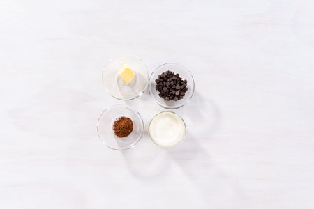 Flat lay. Ingredients in glass bowls to bake chocolate bundt cake with chocolate frosting.