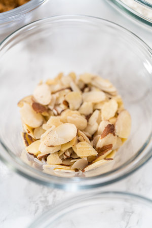 Measured ingredients in glass mixing bowls to bake lemon poppy seed muffins.の写真素材