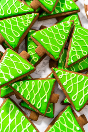 Many Christmas gingerbread cookies with royal icing.