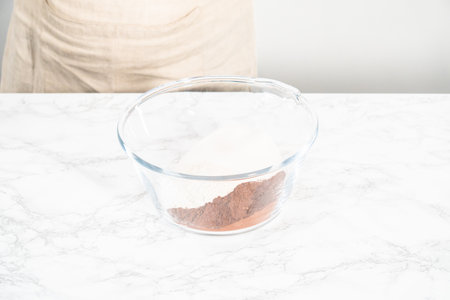 Mixing ingredients in a glass mixing bowl to bake a chocolate cupcake.の写真素材