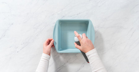 Flat lay. Lining baking sheet with parchment paper to bake peppermint brownies.の写真素材