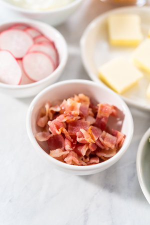 Pressure Cooker Baked Potatoes. Garnishes in small pinch bowls to serve over the baked potatoes.の写真素材
