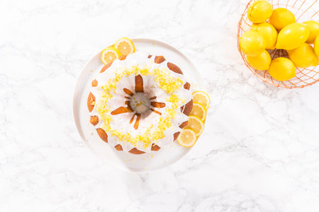 Flat lay. Lemon bundt cake decorated with lemon zest on a cake stand.の写真素材