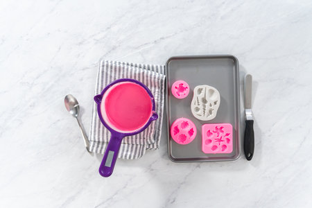 Flat lay. Making sea-shaped chocolates to decorate chocolate-dipped pretzels twists.の写真素材