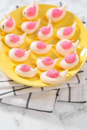 Freshly baked Easter meringue cookies in the shape of birds.の写真素材