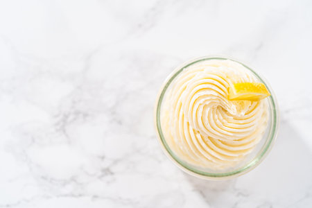 Swirl lemon buttercream frosting in a small glass bowl.の写真素材