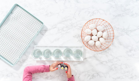 Flat lay. Easter egg coloring. Mixing food coloring with water and a dash of white vinegar to dye...