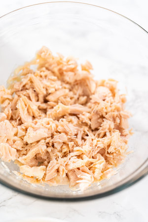 Measured ingredients in glass mixing bowls to make macaroni salad with chicken.の写真素材