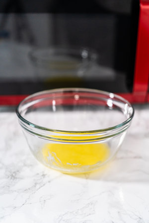 Melting stick of unsalted butter in a microwave.の写真素材