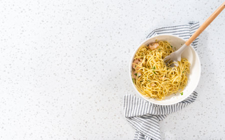 Flat lay. Serving homemade shrimp scampi with linguine pasta garnished with fresh parsley.の写真素材