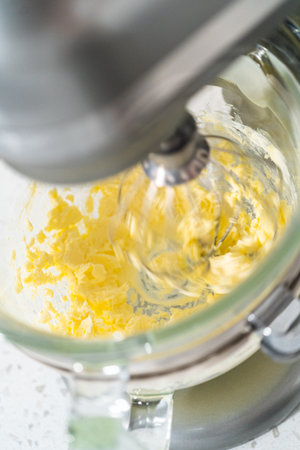 Whipping ingredients in a stand electric mixer to make dulce de leche buttercream frosting.の写真素材