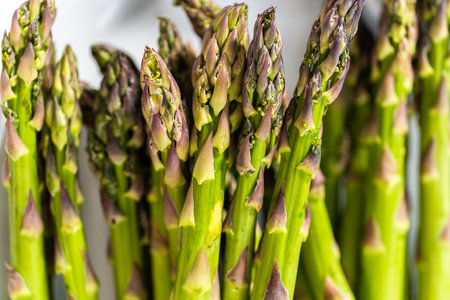 Measured ingredients in glass mixing bowls to steam asparagus.の写真素材