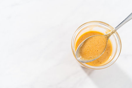 Caramel filling for bundt cake in a glass jar on the kitchen counter.の写真素材