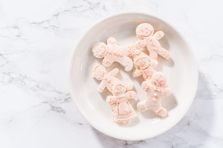Chocolate gingerbread man with glitter on a white plate.