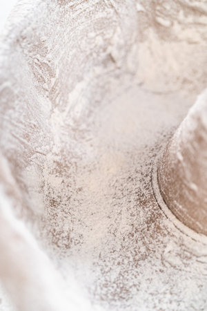 Greasing metal bundt cake pan to bake a simple vanilla bundt cake.の写真素材