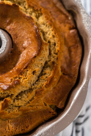 Cooling freshly baked eggnog bundt cake on a kitchen counter.の写真素材