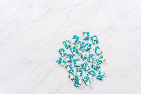 Flat lay. Mini mermaid chocolate bars drizzled with white chocolate, sprinkling with white pearl...