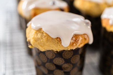 Glazing mini Easter bread kulich with a white lemon glaze.の写真素材