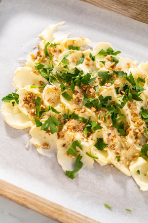 Spreading unsalted butter at room temperature to prepare a vegetarian party butter board for a party.の写真素材