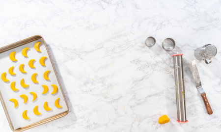 Flat lay. Lemon wedge cookies with lemon glaze. Rolling cookie dough with an adjustable rolling pin...