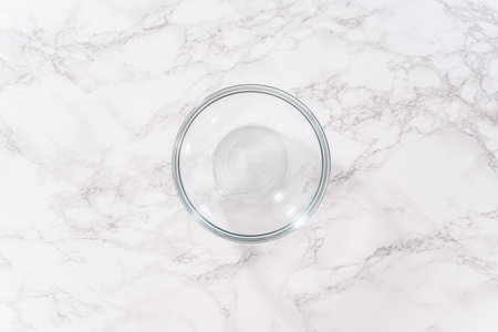 Flat lay. Activating an instant yeast in a glass mixing bowl.の写真素材