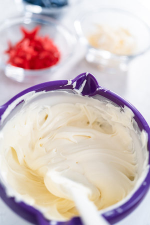 Melting store-bought buttercream frosting in candy melting pot to glaze bundt cake.の写真素材