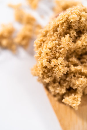 Light brown sugar on a marble counter top.の写真素材