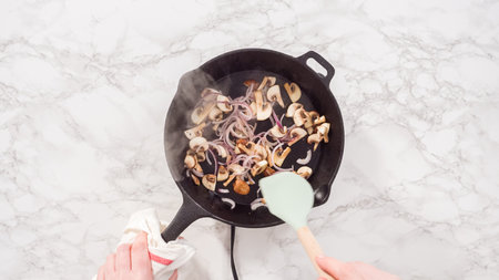 Flat lay. Step by step. Sauteeing purple onion and mushrooms for spinach and ham frittata.の写真素材