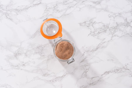 Flat lay. Preparing cinnamon sugar in a glass mason jar.の写真素材