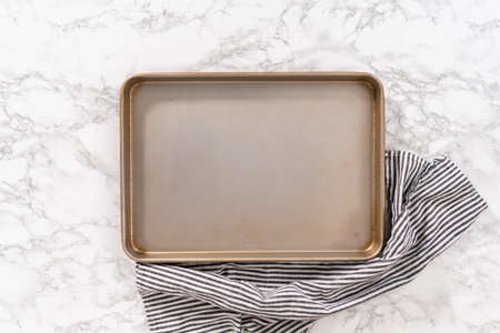 Flat lay. Empty baking sheet lined with parchment paper ready for baking.の写真素材