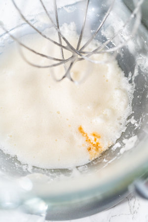 Mixing ingredients in kitchen mixer to bake Easter meringue cookies.の写真素材