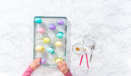 Flat lay. Easter egg coloring. Painting Easter eggs with gold luster.