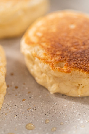 Preparing eggnog pancakes in a nonstick frying pan.の写真素材