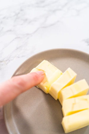 Softened sticks of unsalted butter on the kitchen counter.