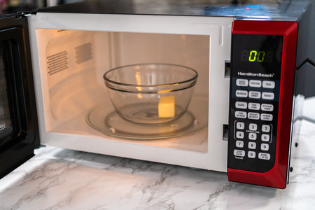 Melting stick of unsalted butter in a microwave.の写真素材