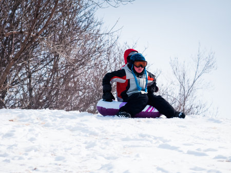 A young boy out playing in the snow.の写真素材