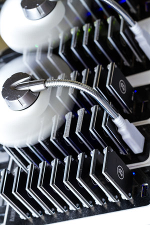 Bitcoin mining USB devices in a row with small fans.の写真素材