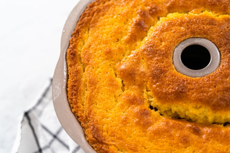 Cooling freshly baked lemon blueberry bundt cake on the kitchen counter.