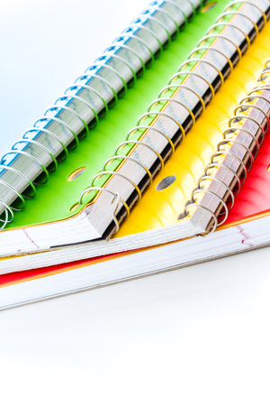 Multicolored spiral notebooks on a white background.の写真素材