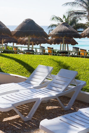 Pool chairs near the swimming pool at the vacation resort in Mexico.の写真素材