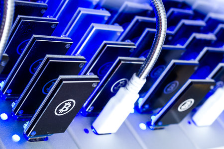 Bitcoin mining USB devices in a row with small fans.の写真素材