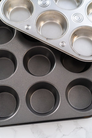 Close-up view. Metal baking pans for cupcakes on a marble countertop.の写真素材