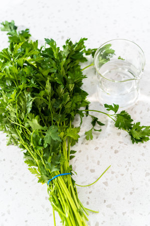 Bunch of fresh parsley is prepared for proper storage.