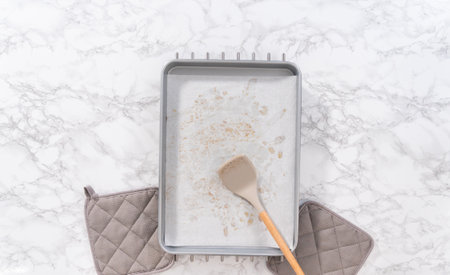 Freshly toasted pecans on a baking sheet lined up with parchment paper.の写真素材