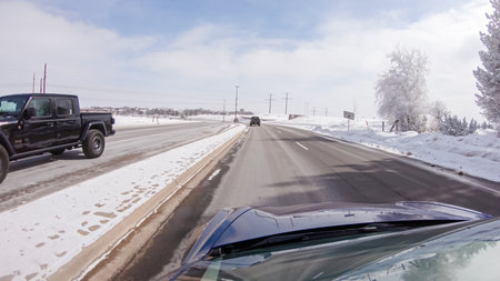 Castle Pines, Colorado, USA-January 30, 2023-Post-winter storm, the drive on a suburban road provides a peaceful journey. The picturesque scene, with snow adorning the landscape, adds to the tranquility of the experience.のeditorial素材