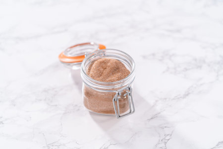 Cinnamon sugar in a glass mason jar on the marble surface.の写真素材