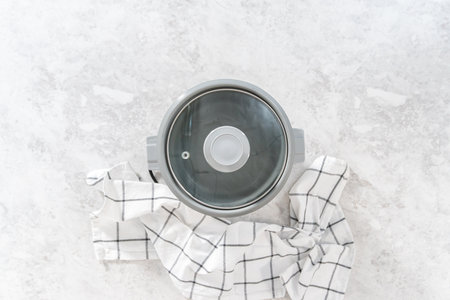 Flat lay. Cooking white rice in a rice cooker.の写真素材