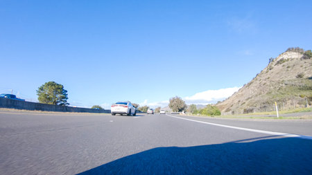 On a crisp winter day, a car cruises along the iconic Highway 1 near San Luis Obispo, California....