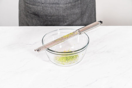 Zesting fresh lime to prepare chili lime salt for Mexican watermelon pops.