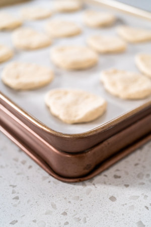 Rolling bread dough with a french rolling pin to bake naan dippers.の写真素材